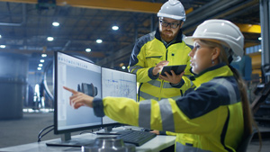 Engineers discuss plans in factory