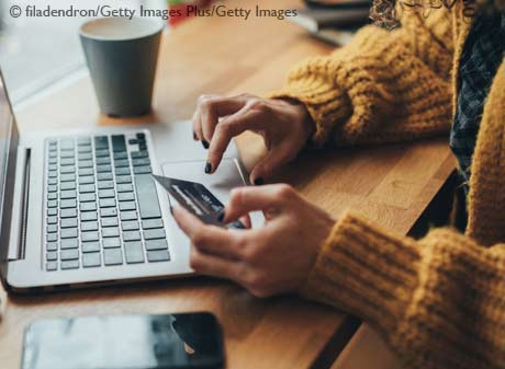 Woman with credit card at laptop