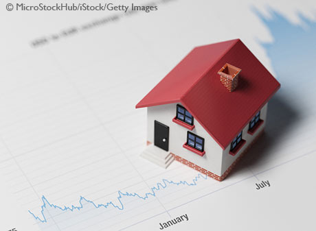 Miniature House on A Blue Financial Graph