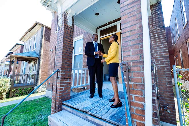 Andre Alexander of Tabernacle CDC greets Yvonne Sparks of the St. Louis Fed