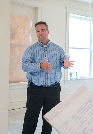 Jaycee Greene of Gateway CDFI stands in a home being renovated.