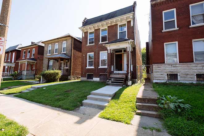 A 2-story brick home with crown molding.