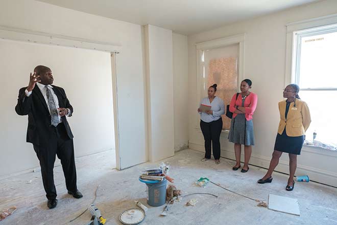 Andre Alexander and the Community Reinvestment Initiatives team in a home being renovated.