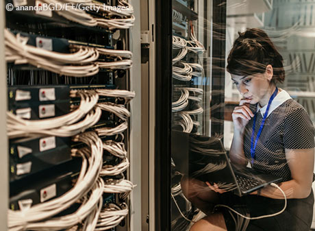 Stock image of female IT engineer working in server room