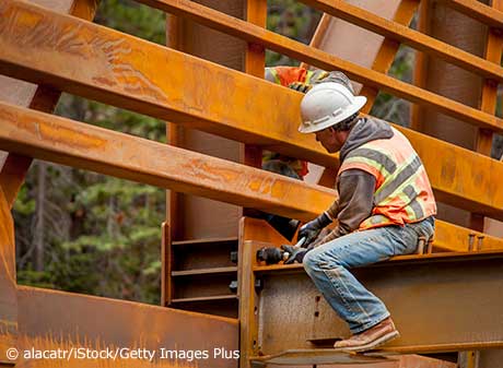 Man working on steel beam at construction site