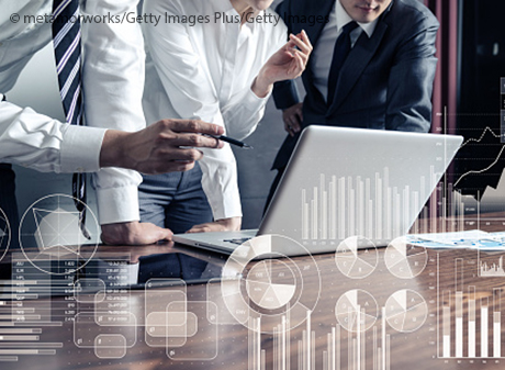 group checking business statistics on computer