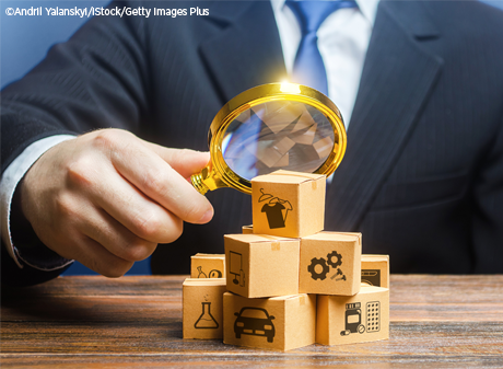 Person focuses a magnifying glass on a pile of miniature boxes, each representing different consumer goods and services.