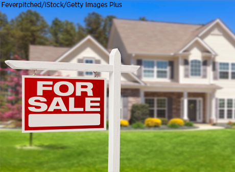 House with For Sale Sign in Front Yard