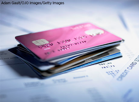 Credit cards stacked on top of numerous credit card billing statements.