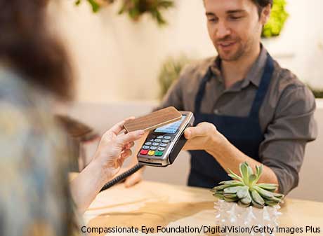 A consumer makes a purchase with a smartphone.