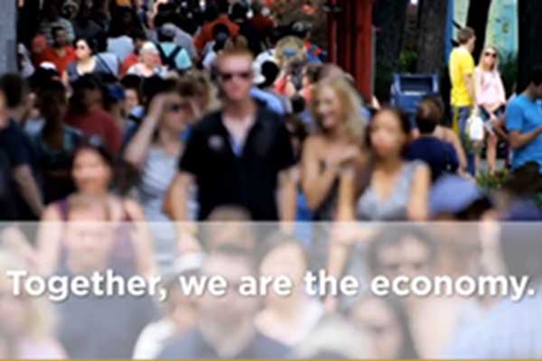 Still image showing people walking down the street in an urban environment