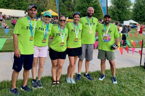 Group of people with race medals around their necks.