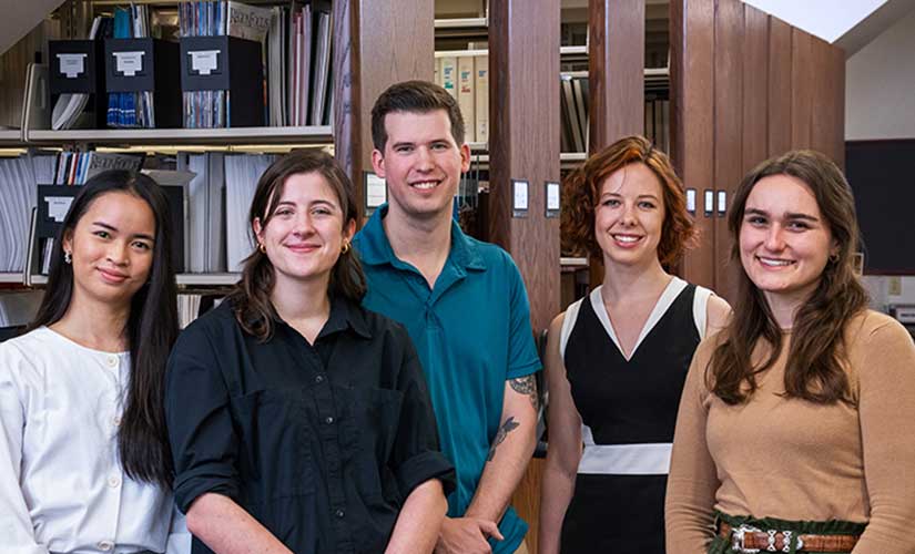 Group of four women and one man in business attire