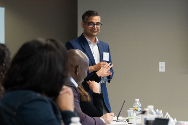 A person gives a conference room audience a presentation.