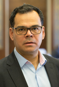 Head and shoulders photograph of a man in business attire.