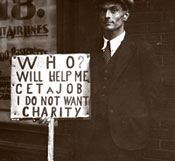 Man in suit has sign reading Who will help me get a job, I do not want charity