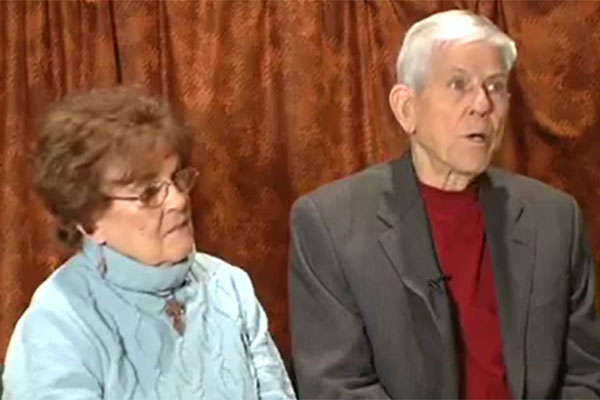 Anna Marie and Raymond McIntyre seated, discussing their Great Depression experience.