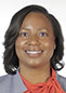 Woman in grey suit jacket and orange blouse