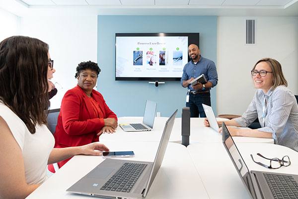Employees sit together in a conference room.