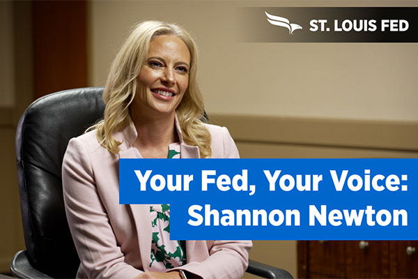 Shannon Newton smiles next to a 'Your Fed, Your Voice' banner.