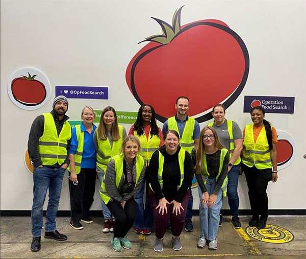 A group of employees in bright yellow vests.