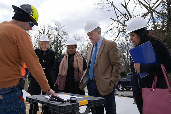 A group of people gather at a construction site