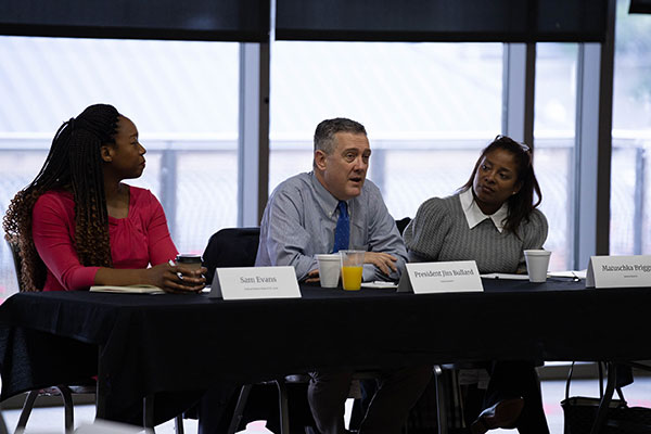 Jim Bullard listened as Matuschka Lindo Briggs addressed a group of community development leaders.
