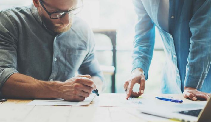 Two people working on design table