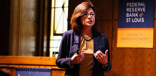 Woman giving closing remarks in auditorium