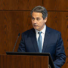 St. Louis Fed President behind lectern.