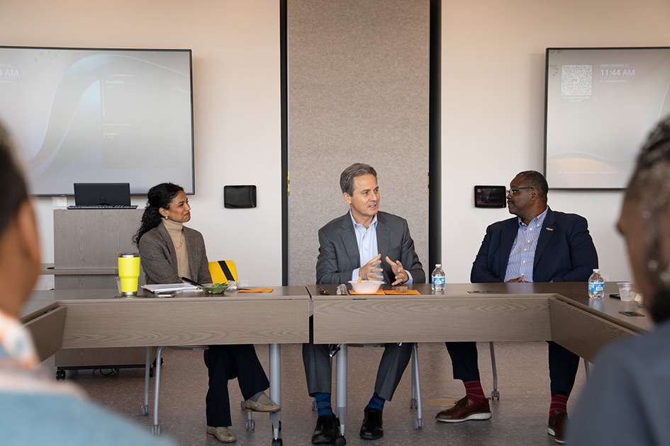 Seated at conference tables with people in business attire, President Musalem gestures as he speaks.