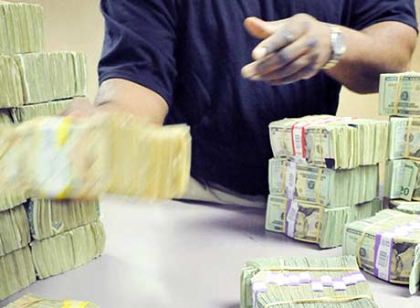 Cash Department Employee sorts currency at Fed.