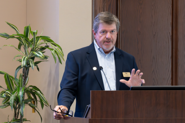 man speaking at podium
