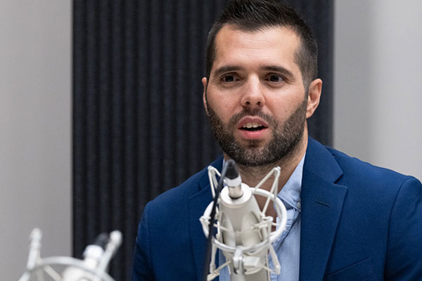 Ricardo Marto speaks into a microphone.
