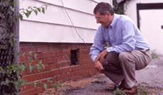 man inspecting a house
