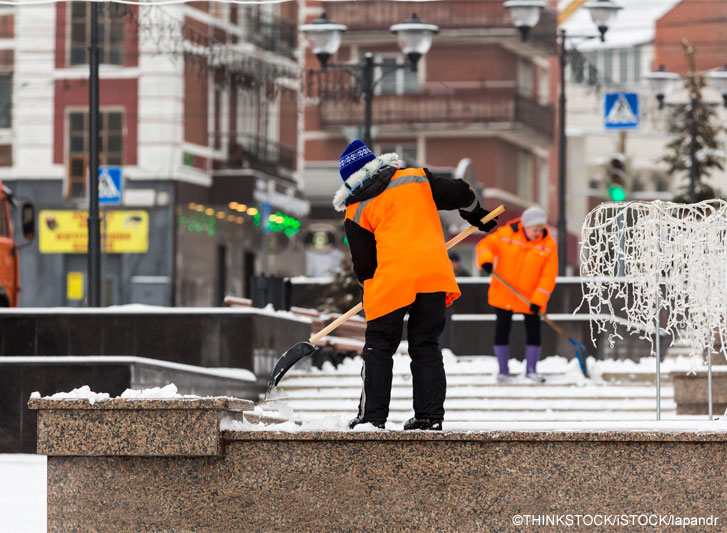 Shoveling snow off sidewalk