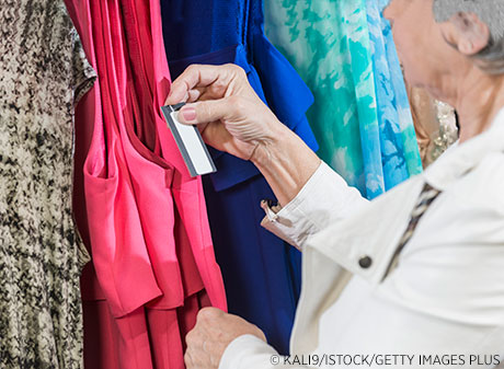 Woman looking at price tag on a dress