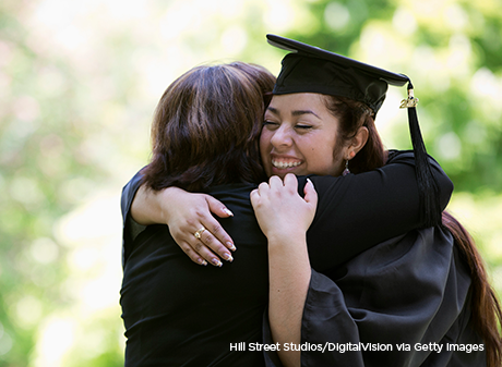 Recent college graduate hugs her mother