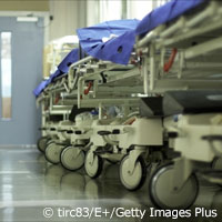 row of empty hospital beds in hallway