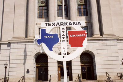 A close up of the sign that stands in front of the Federal Building in downtown Texarkana. Half of the building is in Texas, the other half in Arkansas. | St. Louis Fed