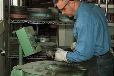 Tourists flock to see artisans at work, such as this pewter smith at the ASL Pewter shop.