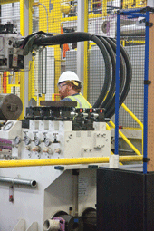 Skilled maintenance worker Justin Wells performs an inspection on one of the GM plant’s new state-of-the-art die-casting machines.