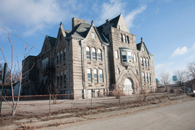 A former public school, built in Romanesque style of Indiana limestone in 1899.