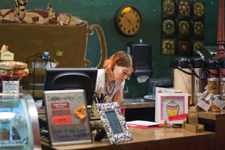 At Creme, a downtown coffee shop, Kelly Creed tends the counter.