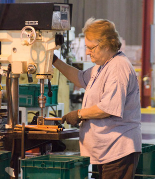 Luvata employee Helen Tharpe works on tubing for a coil assembly.