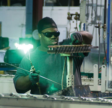 At Luvata, a maker of commercial and industrial coils, James Jones brazes together an assembly to be installed on a coil.