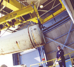 Picture of a crane operator unloading a cylinder filled with uranium hexafluoride at the Paducah plant.