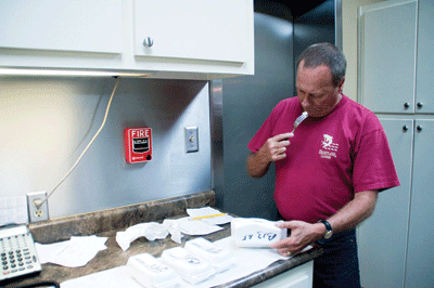 Stanley Marshall, Heartland Catfish’s full-time flavor taster, does his job on a sample he’s just microwaved. | St. Louis Fed