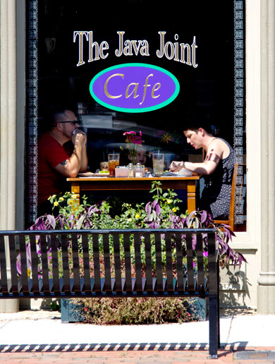 Customers relaxing over a meal at one of Main Street's busy establishments.