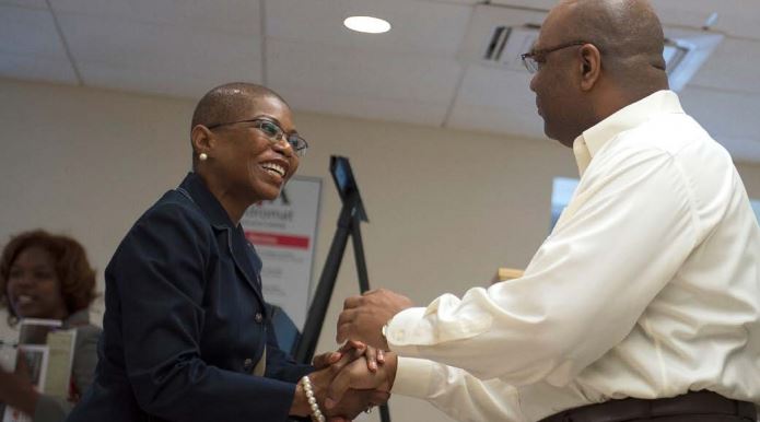 Yvonne Sparks shaking hands with man.